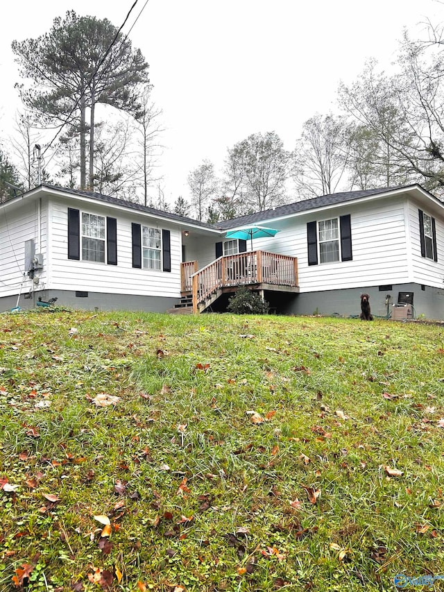 back of property featuring a lawn and a wooden deck