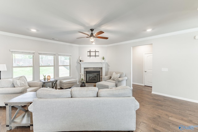 living area with dark wood-style floors, baseboards, ceiling fan, and ornamental molding