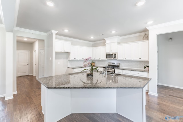 kitchen featuring dark wood finished floors, white cabinets, and appliances with stainless steel finishes