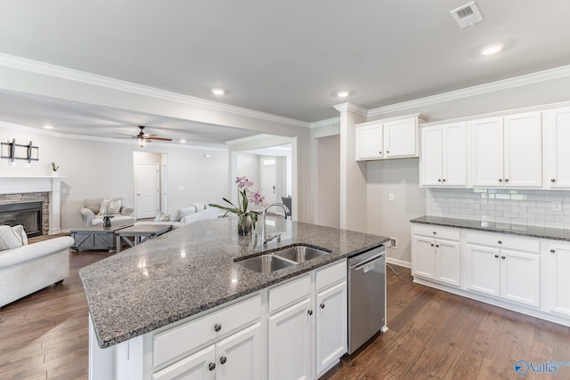 kitchen featuring visible vents, dark wood-type flooring, a sink, white cabinets, and dishwasher