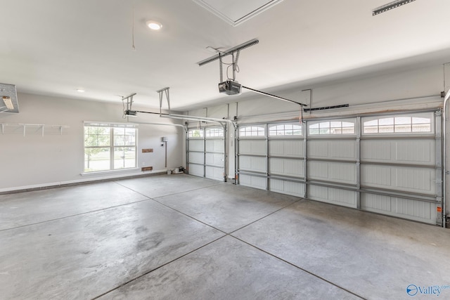 garage with a garage door opener and baseboards