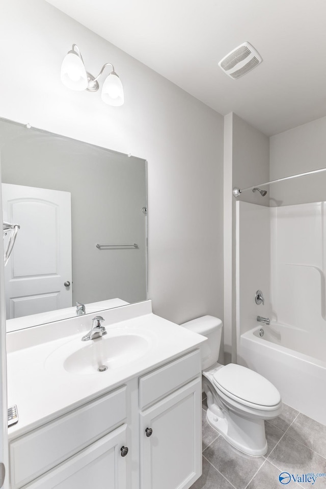 bathroom with vanity, visible vents, tile patterned flooring, shower / bathing tub combination, and toilet