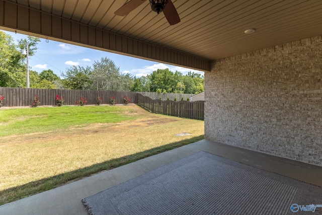 view of yard featuring a fenced backyard, a patio, and ceiling fan