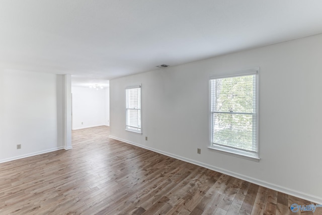 empty room featuring light hardwood / wood-style floors and a wealth of natural light