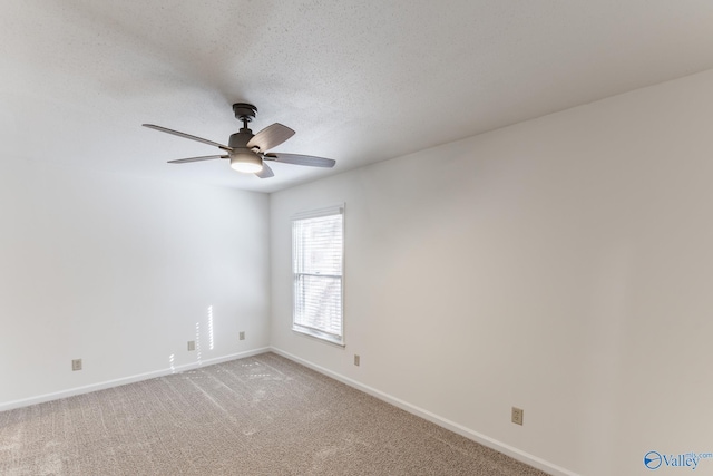 carpeted empty room featuring a textured ceiling and ceiling fan