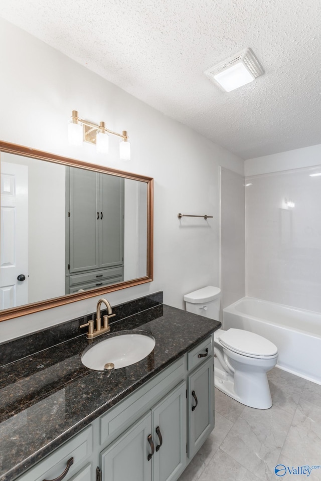 full bathroom featuring vanity, toilet, a textured ceiling, and tub / shower combination