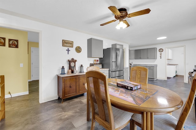 dining space featuring ceiling fan and crown molding