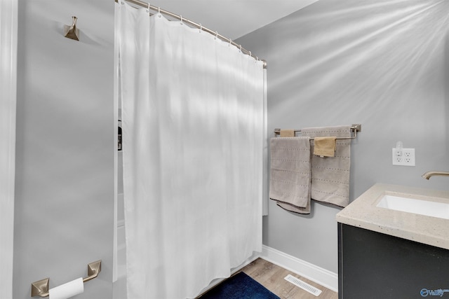 bathroom with hardwood / wood-style floors and vanity