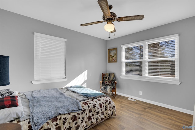 bedroom with ceiling fan and hardwood / wood-style floors