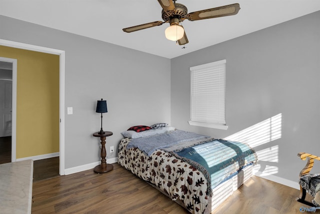 bedroom with ceiling fan and dark wood-type flooring