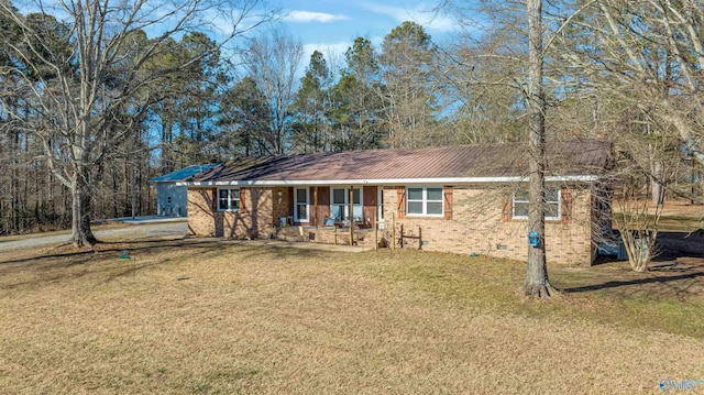 single story home featuring covered porch and a front yard