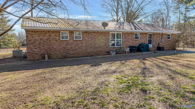 rear view of property with cooling unit