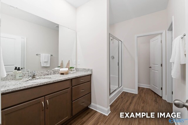 122 Burdine St, New Market, AL 35761 - full bath with baseboards, a shower stall, wood finished floors, and vanity
