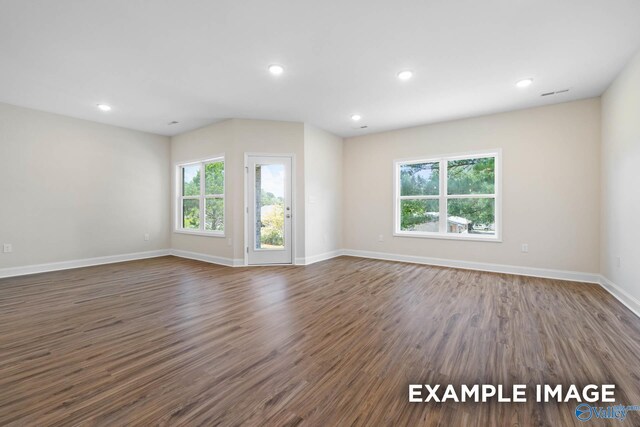 122 Burdine St, New Market, AL 35761 - unfurnished living room featuring baseboards, recessed lighting, and dark wood-type flooring