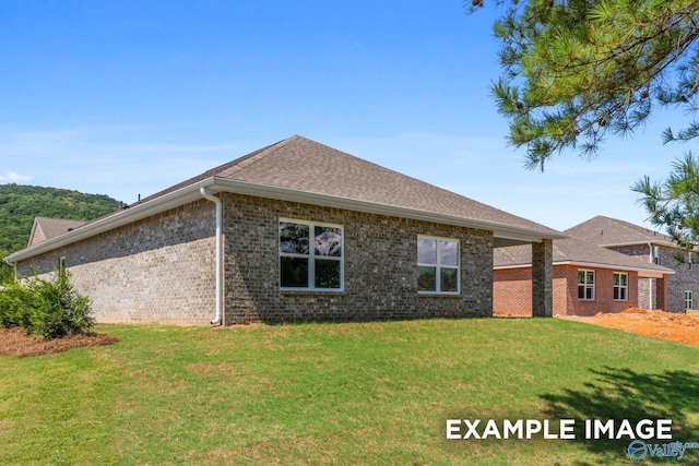 122 Burdine St, New Market, AL 35761 - rear view of property featuring a lawn, brick siding, and roof with shingles