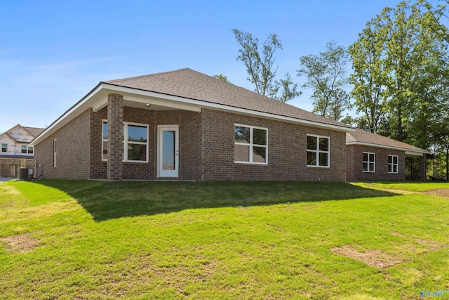122 Burdine St, New Market, AL 35761 - back of house with brick siding, a yard, and cooling unit
