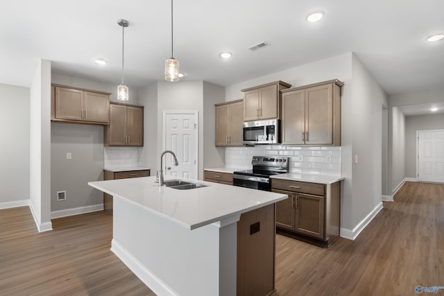 122 Burdine St, New Market, AL 35761 - kitchen with backsplash, baseboards, appliances with stainless steel finishes, and a sink