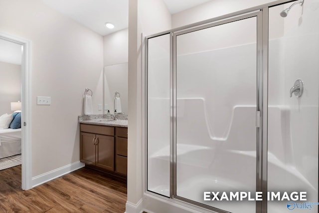 122 Burdine St, New Market, AL 35761 - ensuite bathroom with vanity, wood finished floors, baseboards, connected bathroom, and a stall shower