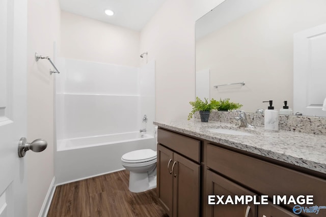 122 Burdine St, New Market, AL 35761 - full bath featuring shower / bath combination, wood finished floors, vanity, baseboards, and toilet