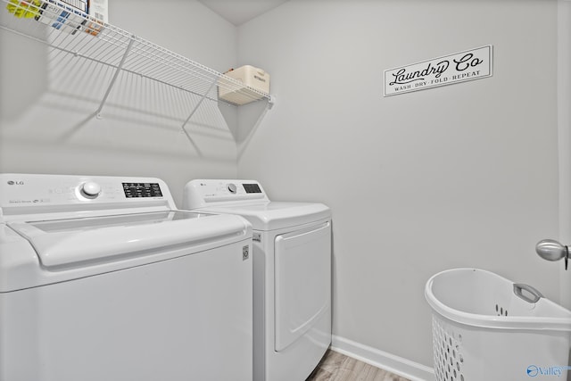 117 Hank Ct, Hazel Green, AL 35750 - laundry room featuring washing machine and dryer and light wood-type flooring
