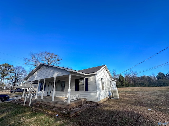 view of front of property featuring cooling unit and covered porch