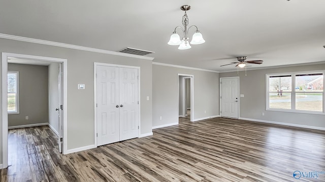 interior space with ceiling fan with notable chandelier, dark wood-type flooring, and ornamental molding