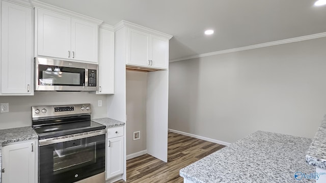 kitchen featuring light stone counters, white cabinets, and appliances with stainless steel finishes