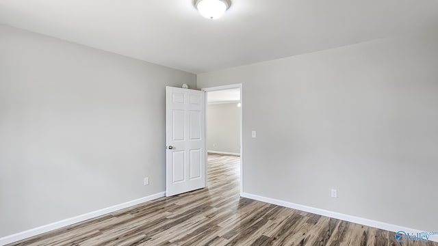 spare room with hardwood / wood-style flooring