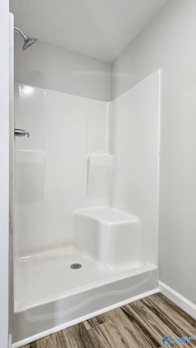 bathroom featuring wood-type flooring and walk in shower