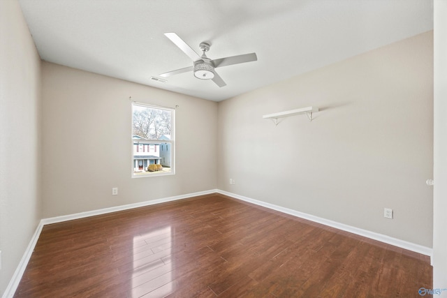 unfurnished room with visible vents, baseboards, a ceiling fan, and dark wood-style flooring