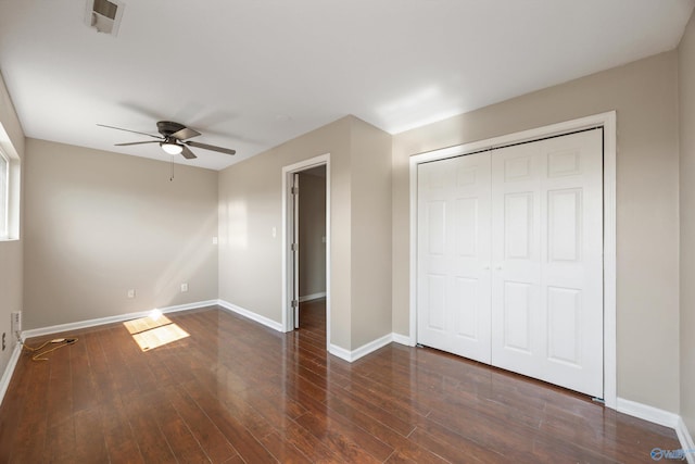 unfurnished bedroom with visible vents, baseboards, wood finished floors, a closet, and a ceiling fan