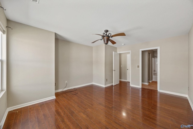 empty room featuring baseboards, ceiling fan, and wood-type flooring