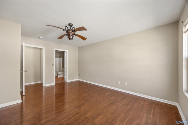 empty room with baseboards, wood finished floors, and a ceiling fan