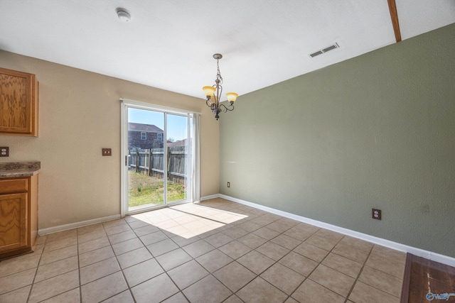 unfurnished dining area featuring visible vents, baseboards, a notable chandelier, and light tile patterned flooring