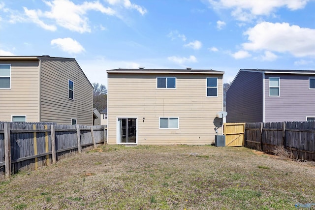 back of house featuring cooling unit, a fenced backyard, and a lawn