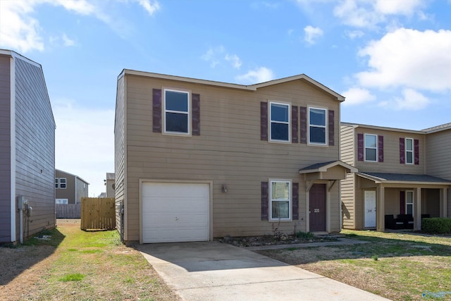 view of front of home featuring an attached garage, driveway, a front yard, and fence