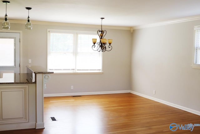 5627 SW Alta Dena St, Huntsville, AL 35802 - unfurnished dining area with light wood-style floors, a chandelier, healthy amount of natural light, crown molding, and baseboards