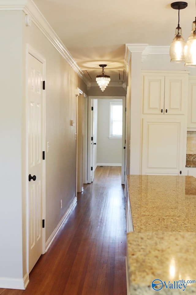 5627 SW Alta Dena St, Huntsville, AL 35802 - hall with a chandelier, crown molding, dark wood-type flooring, and baseboards