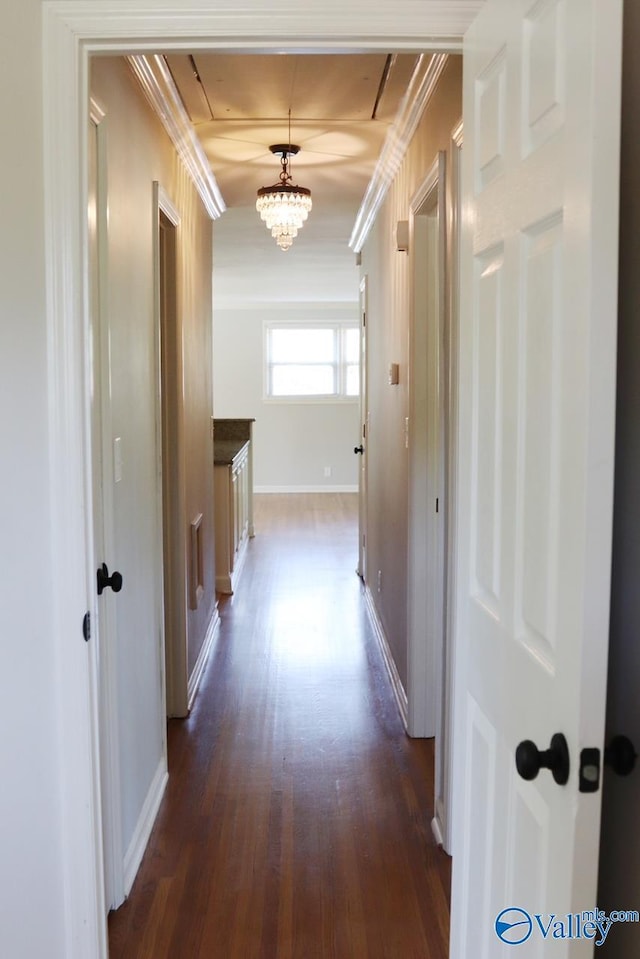 5627 SW Alta Dena St, Huntsville, AL 35802 - hall with dark wood finished floors, ornamental molding, baseboards, and a chandelier