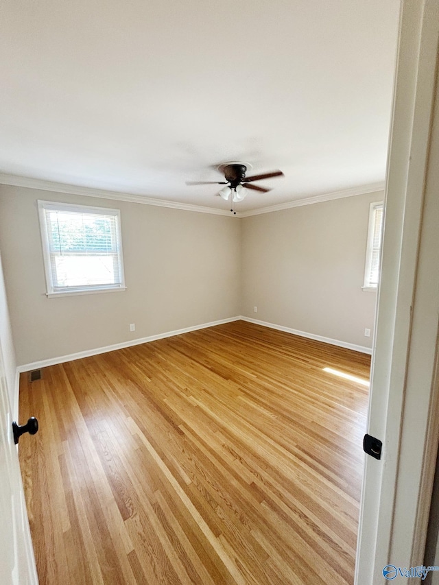 5627 SW Alta Dena St, Huntsville, AL 35802 - spare room with ornamental molding, baseboards, light wood-style flooring, and ceiling fan