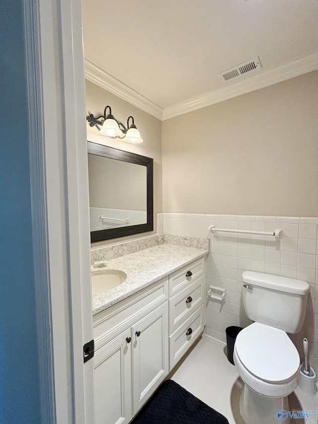5627 SW Alta Dena St, Huntsville, AL 35802 - bathroom with vanity, toilet, crown molding, wainscoting, and tile walls