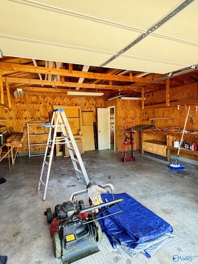 5627 SW Alta Dena St, Huntsville, AL 35802 - garage featuring a workshop area and wood walls