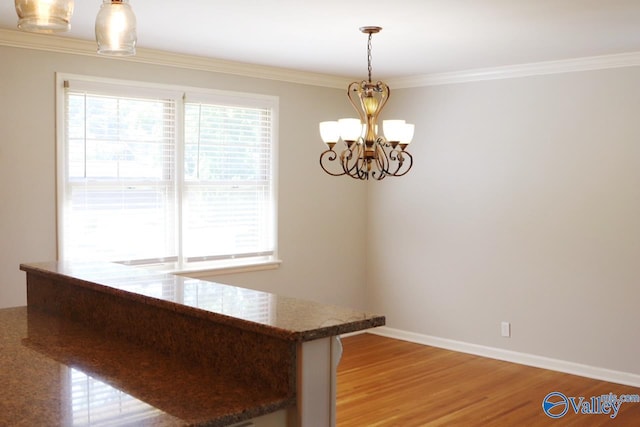 5627 SW Alta Dena St, Huntsville, AL 35802 - unfurnished dining area featuring healthy amount of natural light, a chandelier, light wood-style floors, and ornamental molding