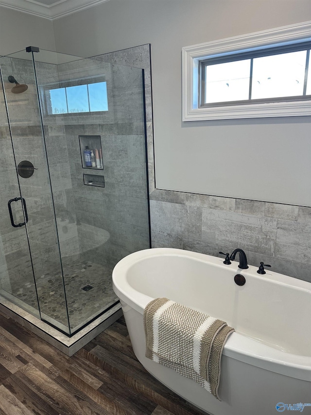 bathroom with wood-type flooring and separate shower and tub