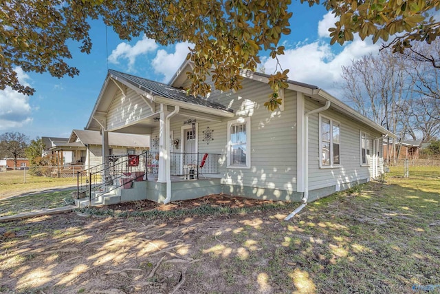 view of front of property featuring a porch and fence