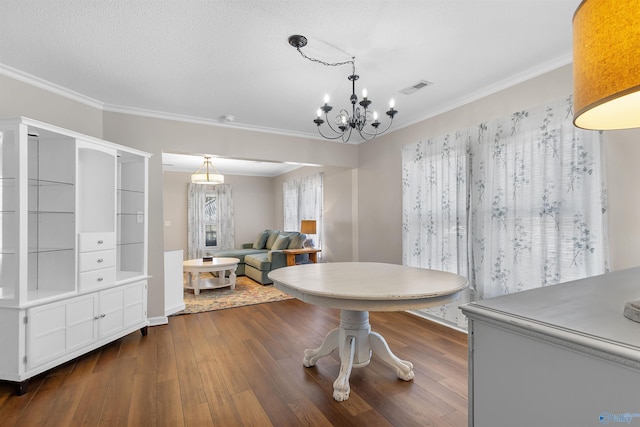 dining area featuring dark wood finished floors, crown molding, and visible vents