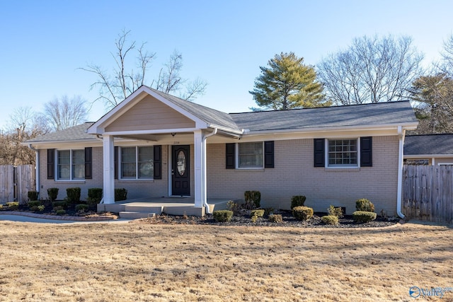 single story home featuring a front yard and covered porch