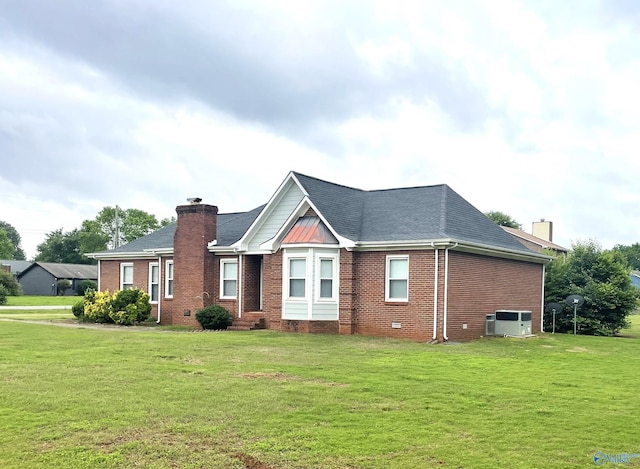 118 Hazelwood Dr, Hazel Green, AL 35750 - view of front facade with a chimney, brick siding, and a front yard