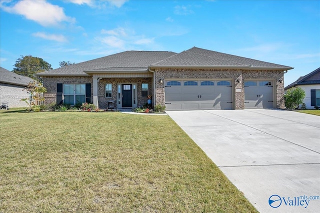 view of front of house with a front yard and a garage