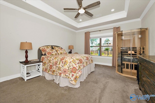 bedroom with a tray ceiling, ceiling fan, carpet floors, and ornamental molding